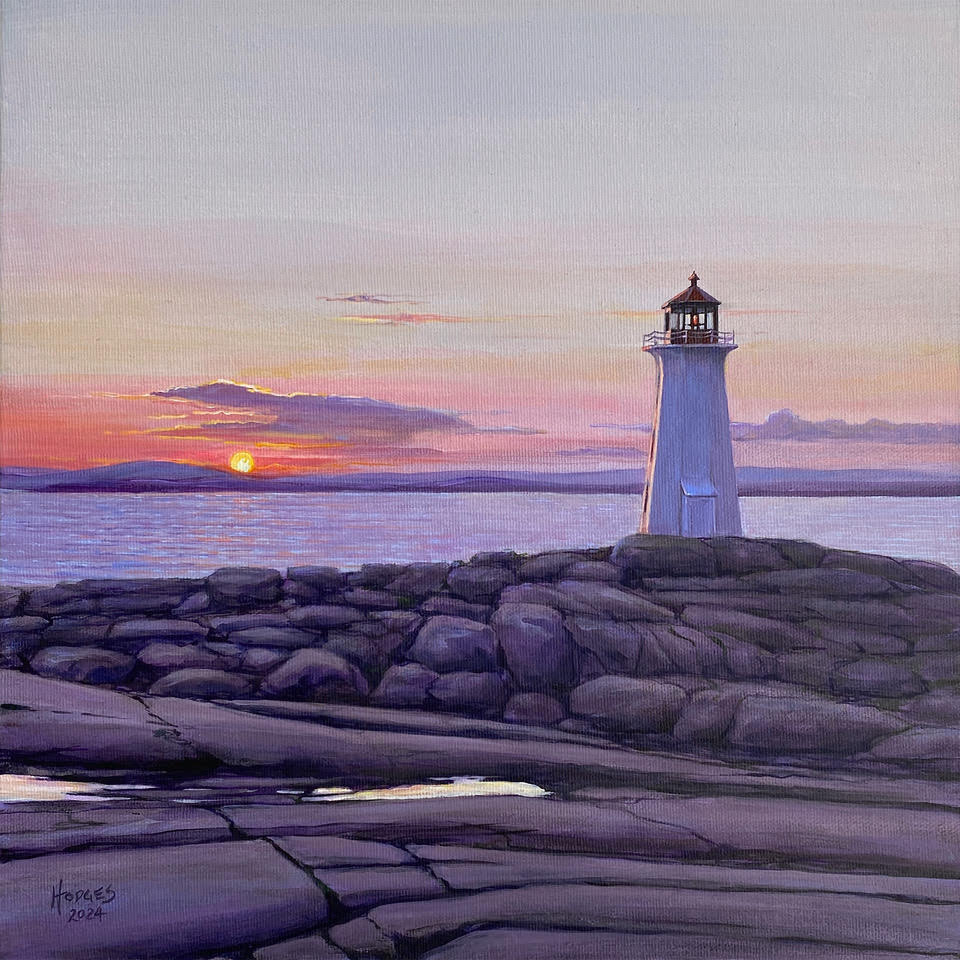 Lighthouse on rocky shore with sunset in the background