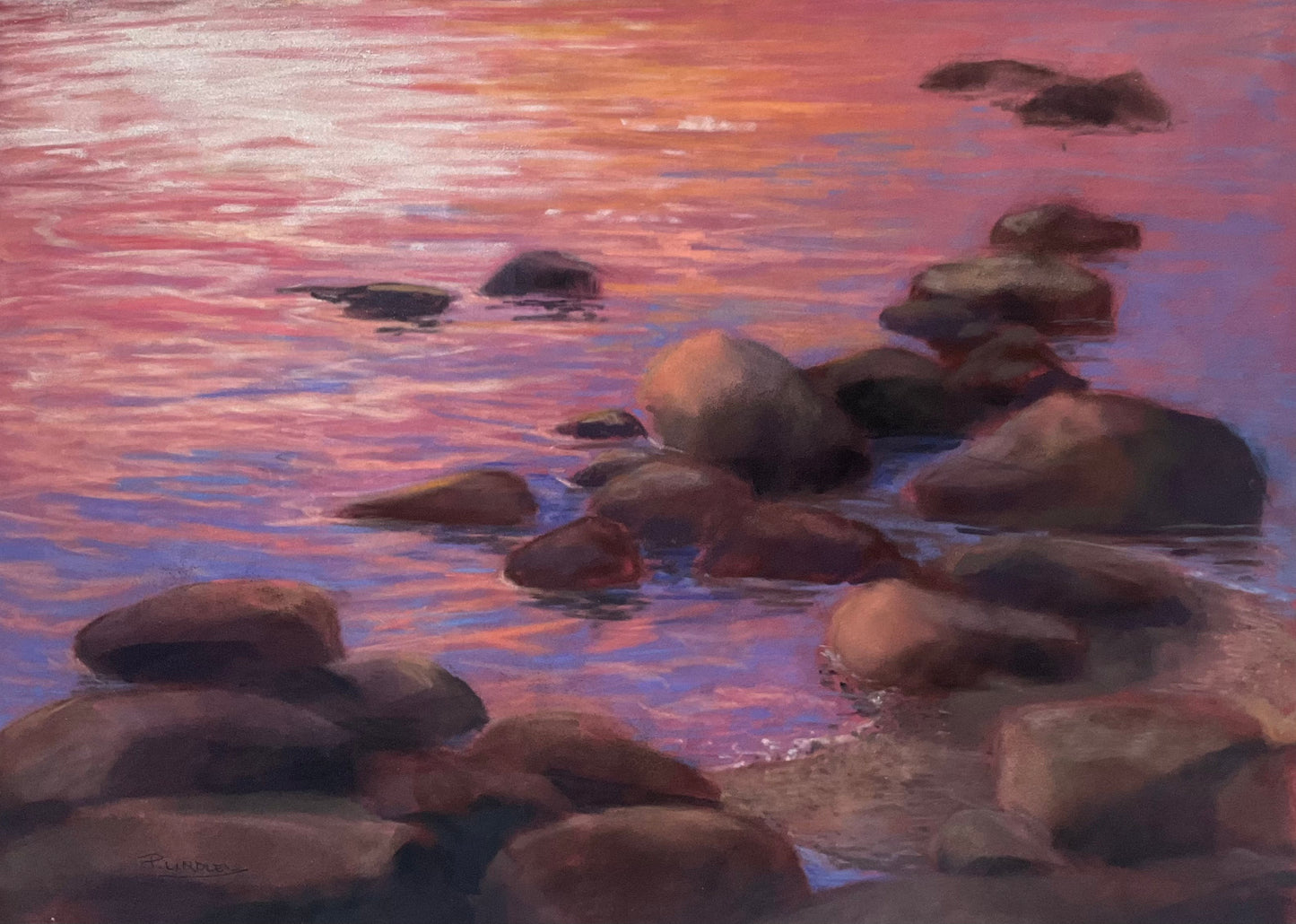 Rocks in water with a pink and purple sunset reflection